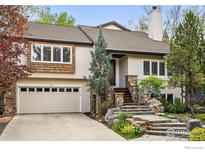 Charming two-story home with stone accents, tiled roof, well-manicured landscaping, and a two-car garage at 3835 Norwood Ct, Boulder, CO 80304