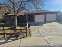 Charming brick home with an attached two car garage and mature trees at 614 Munson Ct, Berthoud, CO 80513