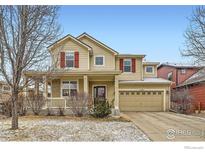 Charming two-story home featuring a welcoming front porch and a two-car garage at 1157 Mircos St, Erie, CO 80516