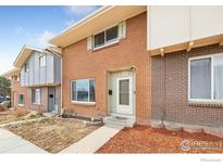 Charming brick townhome with a well-maintained front yard, providing a welcoming curb appeal at 1187 Milky Way, Thornton, CO 80260