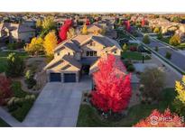 Beautiful two-story home with stone accents, three-car garage and colorful foliage at 13878 Barbour St, Broomfield, CO 80023