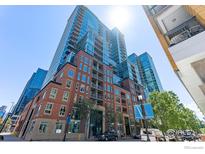 Stunning high-rise building featuring glass and brick facade, complemented by lush landscaping at 1700 Bassett St # 1303, Denver, CO 80202