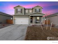 Charming two-story home with a two-car garage and covered front porch at 2509 Alto St, Fort Lupton, CO 80621