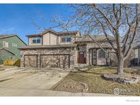 Charming two-story home with stone accents, a three-car garage, and a well-maintained front yard at 270 Terra Vista St, Brighton, CO 80601