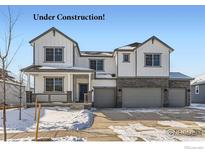 New construction two-story home with attached three-car garage in snowy neighborhood at 2748 Crystal Springs, Longmont, CO 80503