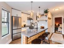 Modern kitchen featuring stainless steel appliances, an island with bar seating, and pendant lighting at 3025 Broadway St # 18, Boulder, CO 80304