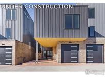 Modern townhomes feature gray siding, brick accents, and sleek garage doors at 3315 Broadway St, Boulder, CO 80304