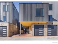 Modern townhome exterior featuring metal siding, brick accents, and attached garages at 3315 Broadway St, Boulder, CO 80304