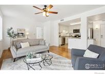 Bright living room featuring stylish furniture, ceiling fan, and an open layout to the kitchen at 4500 Baseline Rd # 3105, Boulder, CO 80303