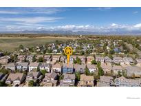 Gorgeous aerial view of a neighborhood near the mountains, with lush greenery and stunning mountain views at 739 Graham Cir, Erie, CO 80516
