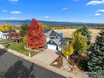 Stunning home with a beautiful yard and mountain views, complemented by solar panels at 1017 Azure Way, Louisville, CO 80027