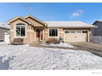 Charming single-Gathering home with a two-car garage, landscaped yard, and inviting curb appeal in a winter setting at 1170 Jefferson Dr, Berthoud, CO 80513