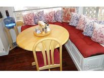 Cozy breakfast nook featuring a round table, cushioned bench, and decorative pillows at 3349 Sentinel Dr, Boulder, CO 80301