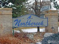 A welcoming entrance sign for the Northcreek community with brick pillars at 3349 Sentinel Dr, Boulder, CO 80301