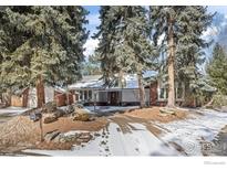 Charming single-story home with brick accents, mature trees, and a snow-dusted front yard at 4862 Silver Sage Ct, Boulder, CO 80301