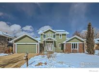 Charming two-story home featuring an attached two-car garage and lovely green siding at 4869 Kellogg Cir, Boulder, CO 80303