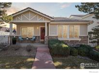 Charming single-story home featuring a welcoming front porch and well-maintained landscaping at 5019 Pasadena Way, Broomfield, CO 80023