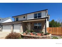 Charming two-story home with brick facade, manicured landscaping, and three-car garage at 560 S 9Th St, Berthoud, CO 80513