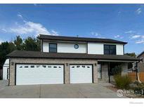 Two-story home featuring a two car garage and neutral color palette at 560 S 9Th St, Berthoud, CO 80513