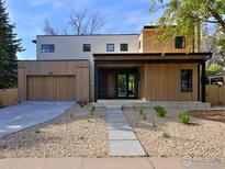 Modern two-story home featuring wood and neutral toned siding and a spacious two-car garage at 864 Iris Ave, Boulder, CO 80304