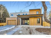 Striking two-story modern home featuring wood accents and a welcoming covered entrance at 864 Iris Ave, Boulder, CO 80304