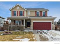 Charming two-story home with a well-manicured lawn and red shutters, complemented by a spacious two car garage at 13850 Meadowbrook Dr, Broomfield, CO 80020