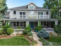 Charming home featuring a covered front porch, second story balconies, and a beautifully landscaped front yard at 1601 Redwood Ave, Boulder, CO 80304