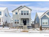 Charming two-story home with a gray facade, inviting front porch, and well-maintained front yard at 182 Sassafras St, Erie, CO 80516