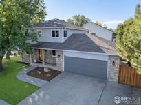 Charming two-story home featuring a two-car garage and beautifully landscaped front yard at 2437 Maplewood E Cir, Longmont, CO 80503