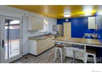 Bright kitchen featuring stainless steel appliances, tile countertops, and colorful ceiling at 830 10Th St, Berthoud, CO 80513