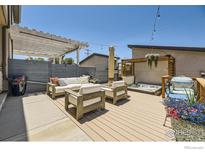 Inviting backyard deck area featuring modern outdoor furniture, a hot tub, and stylish string lights for outdoor relaxation at 2235 Cherokee St, Denver, CO 80223