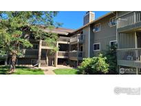 Multi-level condo with a covered stairwell and open air wooden patios at 695 Manhattan Dr # 216, Boulder, CO 80303