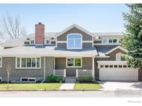 Charming two-story home with a welcoming front porch and well-manicured lawn at 730 Evergreen Ave, Boulder, CO 80304