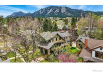 Stunning exterior of home with lush landscaping and Flatiron mountains in the background at 851 14Th St, Boulder, CO 80302