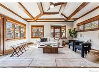 Spacious living room with coffered ceiling, natural light, neutral decor, and hardwood floors at 851 14Th St, Boulder, CO 80302