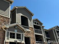 A beautiful condominium complex with stone and siding details and private balconies at 1465 Blue Sky Cir # 303, Erie, CO 80516