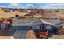 Charming ranch-style home with a well-maintained yard and a welcoming front porch, plus an oversized attached garage at 200 Bothun Rd, Berthoud, CO 80513