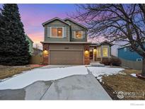 Charming two-story home with a two car garage, a brick facade, and a well-maintained lawn at 2166 Dailey St, Superior, CO 80027