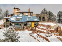 Unique home featuring a blue roof, stone facade and a vibrant yellow front door at 2796 Lee Hill Dr, Boulder, CO 80302