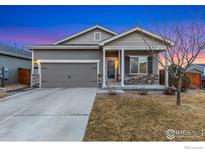 Charming single-story home with a two-car garage, stone accents, and a well-maintained front yard at 2912 Urban Pl, Berthoud, CO 80513