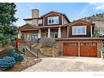 Charming multi-story home with stone accents, a two-car garage, and a professionally landscaped front yard at 2925 4Th St, Boulder, CO 80304