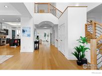 Bright foyer featuring wood floors, a grand staircase, and an open floor plan at 2925 4Th St, Boulder, CO 80304