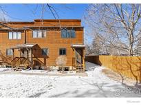 Charming townhouse showcasing a wood exterior, set against a snowy landscape and clear blue sky at 3323 Hickok Pl, Boulder, CO 80301