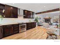 Spacious kitchen with dark wood cabinetry, stainless steel appliances, and a light-filled breakfast nook at 3323 Hickok Pl, Boulder, CO 80301