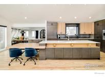 Bright kitchen with modern cabinetry, large island with seating, and stainless steel appliances at 412 Wild Horse Cir, Boulder, CO 80304