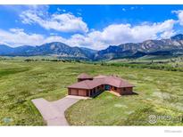 Stunning aerial view of a house with mountain views and sprawling green landscape at 4702 Eldorado Springs Dr, Boulder, CO 80303