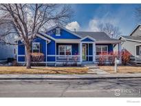 Charming blue single Gathering home with a welcoming front porch and well-manicured landscaping at 5126 Mt Buchanan Ave, Frederick, CO 80504