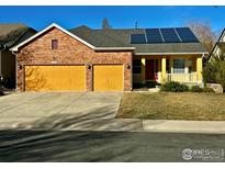 Charming home featuring a brick facade, solar panels, an attached two-car garage and front porch at 6596 Silverleaf Ave, Firestone, CO 80504