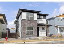 Beautiful two-story home featuring stone accents, white siding, and modern black trim at 735 Discovery Pkwy, Superior, CO 80027