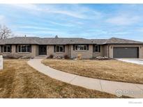 Ranch style home with a brick exterior, gray roof, attached garage and well maintained yard at 8309 W 69Th Way, Arvada, CO 80004